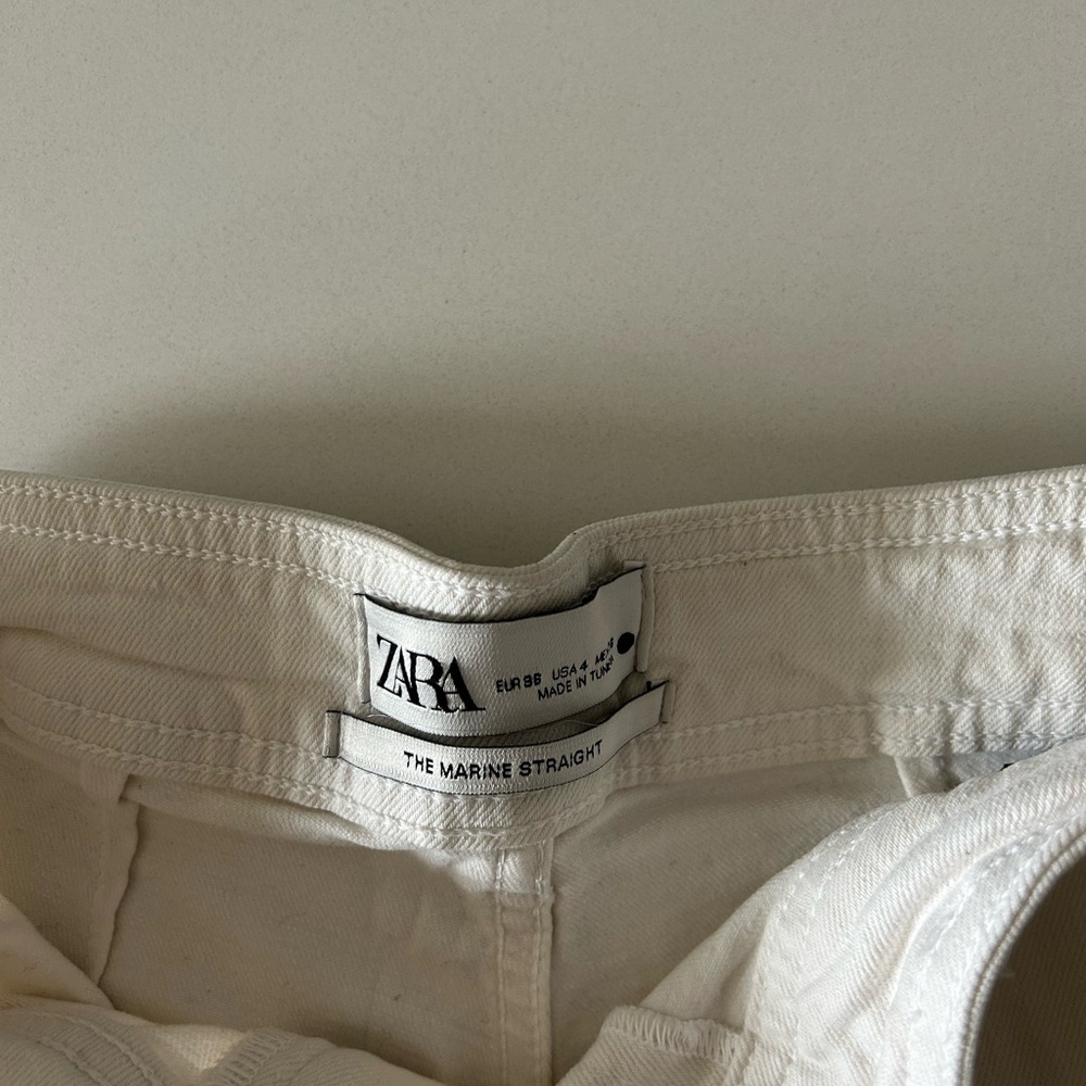 White Zara flares with no hemmed bottom.